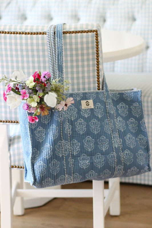 French blue block-print mahjong tote on a gingham chair with fresh flowers