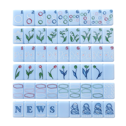 Dear Mahjong x Kayce Hughes mahjong set, full layout of all 160 soft blue engraved tiles with Kayce Hughes artwork: circles dots, lily of the valley bams, map craks, flowers, dragons, winds and brush-lettered jokers
