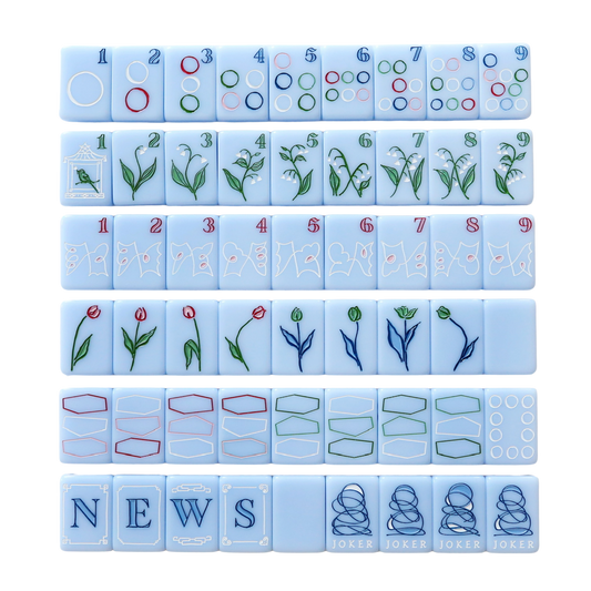 Dear Mahjong x Kayce Hughes mahjong set, full layout of all 160 soft blue engraved tiles with Kayce Hughes artwork: circles dots, lily of the valley bams, map craks, flowers, dragons, winds and brush-lettered jokers
